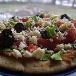 Pita Pizzas With Hummus, Spinach, Olives, Tomatoes & Cheese recipe