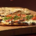 Grilled Pizzettas with Parmigiano, Prosciutto and Arugula and with Taleggio and Puttanesca (Anne Burrell) recipe