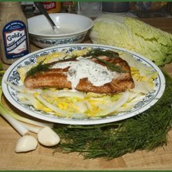 Salmon With a Creamy Sauce on a Bed of Greens