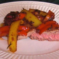 Steak Topped With Peppers and Onions